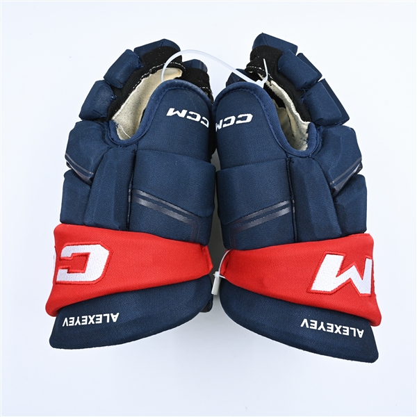 Alexeyev, Alexander<br>CCM HGQL Gloves - Worn in Stadium Series Practice & Warm-Up<br>Washington Capitals 2022-23<br>#27 Size: 14"
